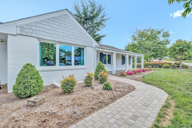 single story home featuring a front yard and brick siding