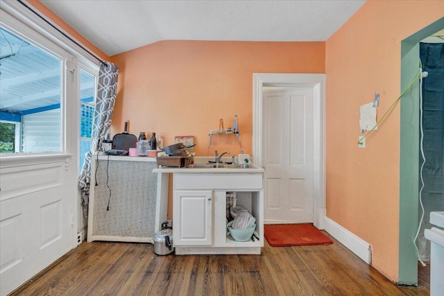 clothes washing area with a sink and wood finished floors