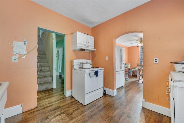 kitchen with ceiling fan, white appliances, arched walkways, white cabinetry, and wood finished floors