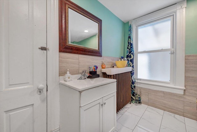 bathroom with vanity and marble finish floor