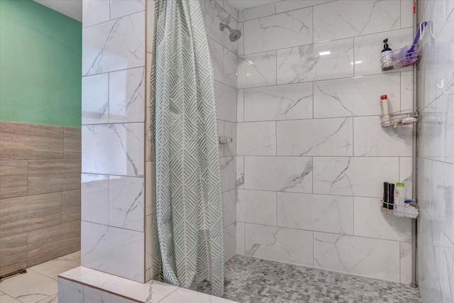bathroom with a tile shower