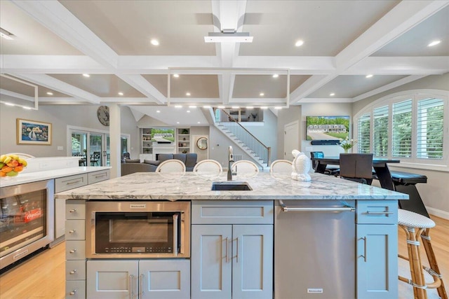 400 Heather Ln, Huddleston, VA 24104 - kitchen with beverage cooler, light wood-type flooring, coffered ceiling, a sink, and open floor plan