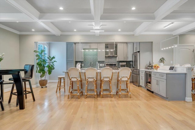 400 Heather Ln, Huddleston, VA 24104 - kitchen with gray cabinetry, wall chimney exhaust hood, a breakfast bar, high end refrigerator, and wine cooler