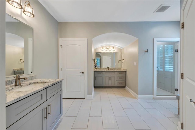 400 Heather Ln, Huddleston, VA 24104 - full bathroom featuring a stall shower, tile patterned floors, two vanities, a chandelier, and baseboards