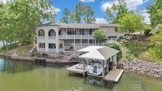 view of dock featuring a water view, boat lift, and stairway
