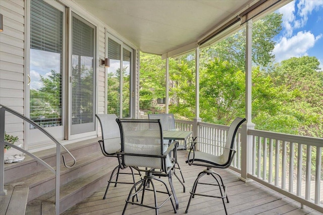 sunroom / solarium featuring outdoor dining area