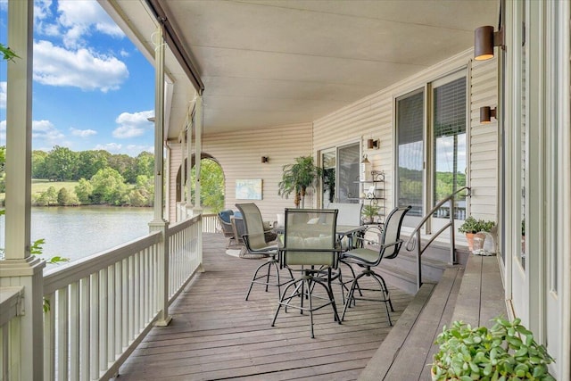 deck featuring a water view and outdoor dining space
