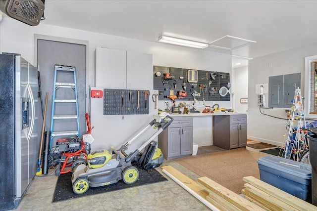 garage with stainless steel refrigerator with ice dispenser