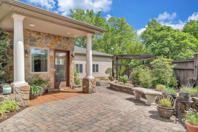view of patio / terrace featuring a pergola and fence