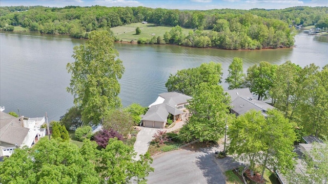 aerial view with a wooded view and a water view