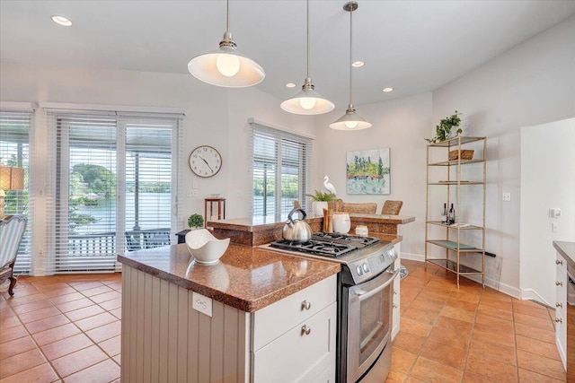 kitchen with light tile patterned flooring, stainless steel range with gas cooktop, pendant lighting, and recessed lighting