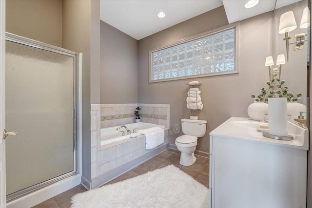 full bath with a stall shower, a garden tub, vanity, and toilet