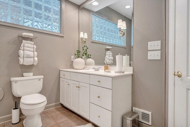 bathroom featuring toilet, baseboards, visible vents, tile patterned floors, and vanity