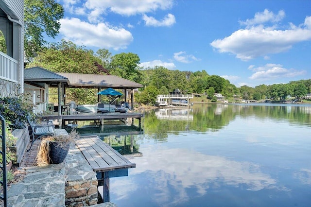 dock area featuring boat lift and a water view