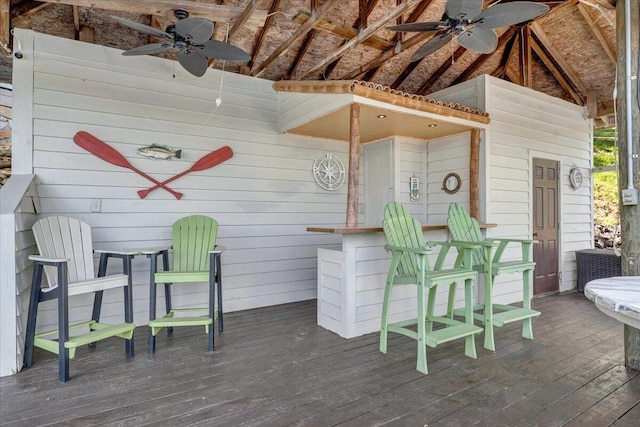 deck featuring exterior bar and a ceiling fan