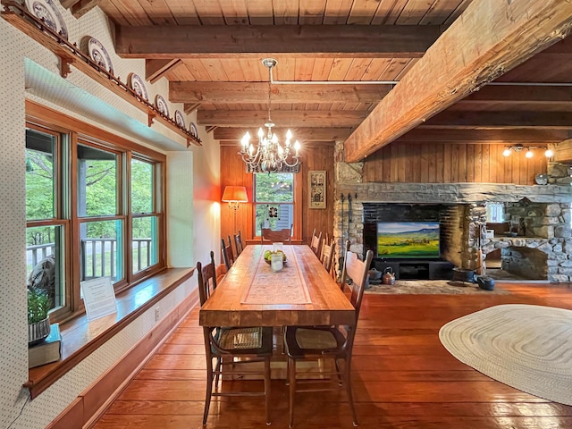 388 Hemlock Ridge Ln, Catawba, VA 24070 - dining room with a glass covered fireplace, hardwood / wood-style floors, wood ceiling, beam ceiling, and a chandelier