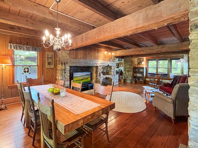 388 Hemlock Ridge Ln, Catawba, VA 24070 - dining room with wooden ceiling, wood-type flooring, a chandelier, a fireplace, and beam ceiling