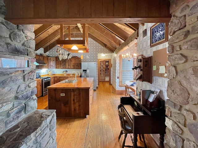 388 Hemlock Ridge Ln, Catawba, VA 24070 - kitchen with butcher block countertops, appliances with stainless steel finishes, a sink, a chandelier, and light wood finished floors