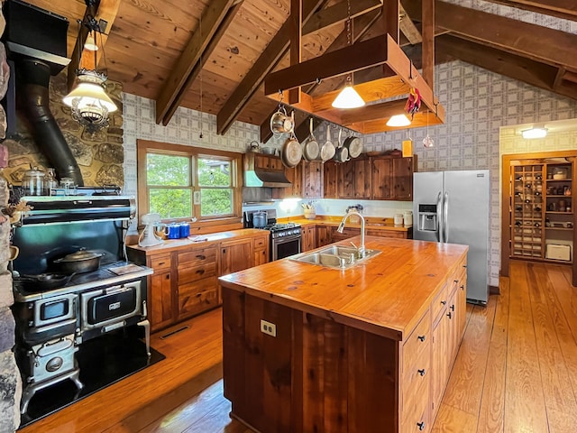 388 Hemlock Ridge Ln, Catawba, VA 24070 - kitchen with wooden counters, a sink, wallpapered walls, appliances with stainless steel finishes, and under cabinet range hood