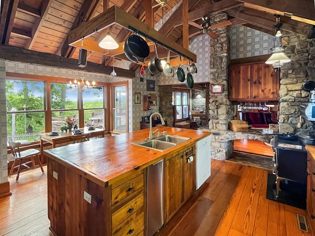 388 Hemlock Ridge Ln, Catawba, VA 24070 - kitchen with butcher block countertops, a sink, light wood-style floors, high vaulted ceiling, and beamed ceiling
