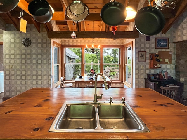388 Hemlock Ridge Ln, Catawba, VA 24070 - kitchen featuring butcher block countertops, wallpapered walls, a sink, and beamed ceiling