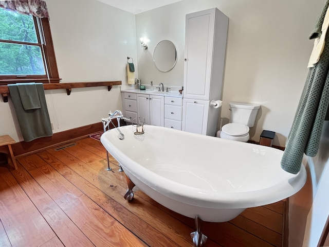 388 Hemlock Ridge Ln, Catawba, VA 24070 - bathroom featuring a freestanding tub, wood finished floors, toilet, and vanity