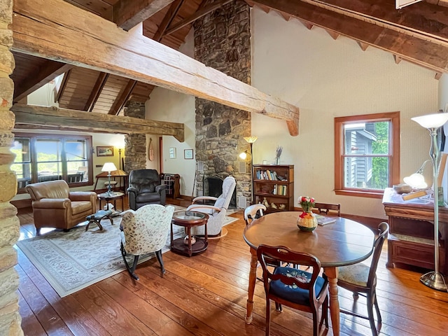 388 Hemlock Ridge Ln, Catawba, VA 24070 - dining room with beam ceiling, wood-type flooring, high vaulted ceiling, a stone fireplace, and wooden ceiling
