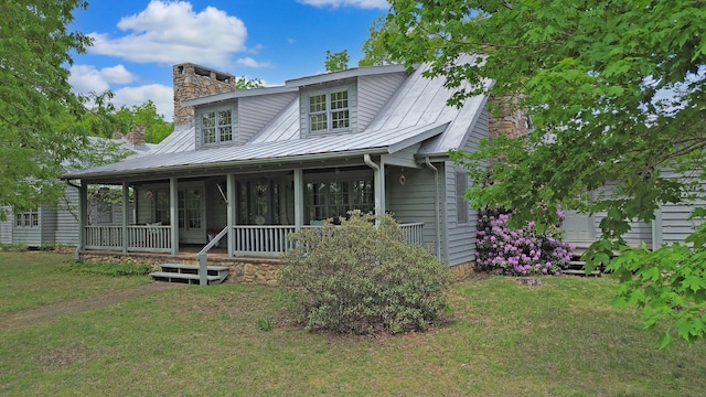 388 Hemlock Ridge Ln, Catawba, VA 24070 - view of front facade with a chimney, a front yard, covered porch, metal roof, and a standing seam roof