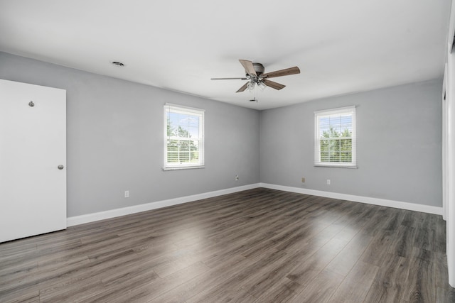 unfurnished room with a wealth of natural light, wood finished floors, baseboards, and ceiling fan