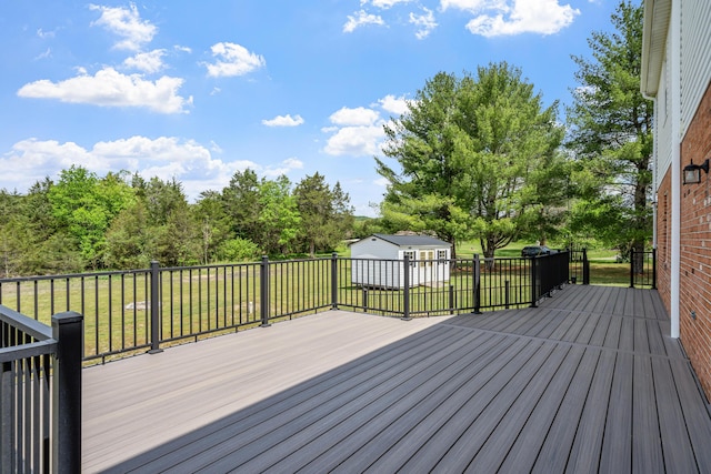 wooden terrace with an outbuilding and a lawn