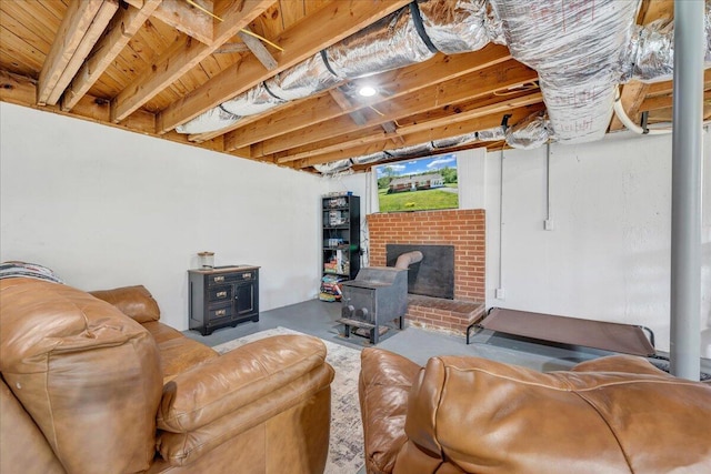 living area featuring a wood stove and concrete flooring