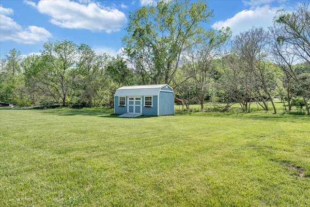 view of yard featuring a storage shed and an outbuilding
