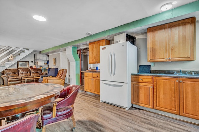 1393 Deepwoods Rd, Hardy, VA 24101 - kitchen featuring freestanding refrigerator, a sink, light wood finished floors, brown cabinets, and dark countertops