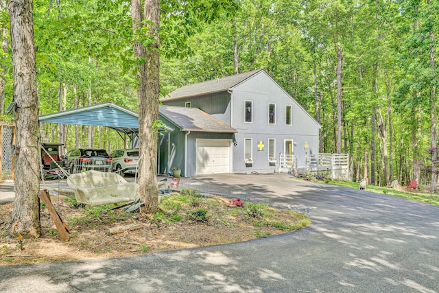 1393 Deepwoods Rd, Hardy, VA 24101 - view of front of home with driveway, a detached carport, an attached garage, a shingled roof, and a forest view