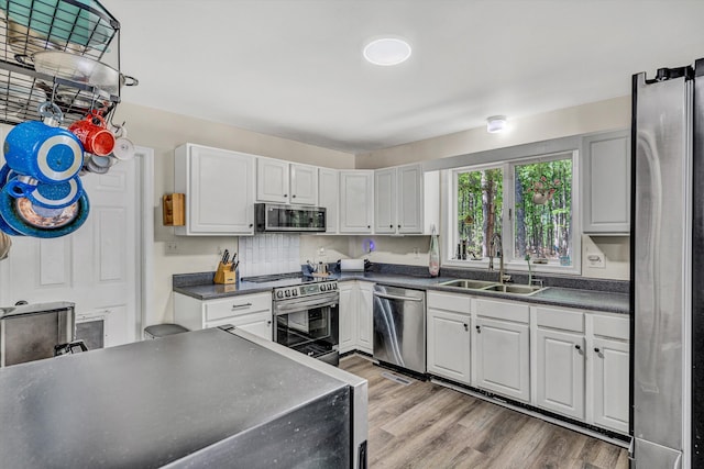 1393 Deepwoods Rd, Hardy, VA 24101 - kitchen featuring stainless steel appliances, a sink, dark countertops, and light wood-style flooring