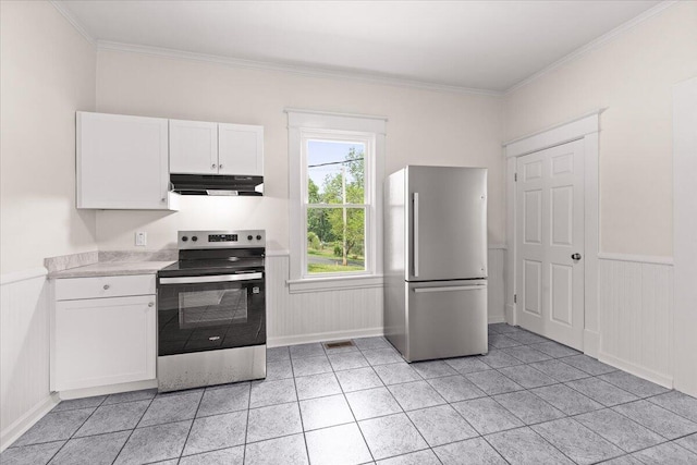 kitchen with ornamental molding, light countertops, under cabinet range hood, white cabinets, and appliances with stainless steel finishes