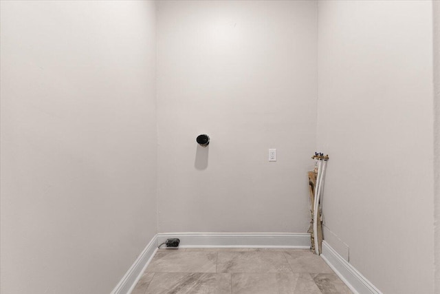 clothes washing area featuring washer hookup, baseboards, and laundry area