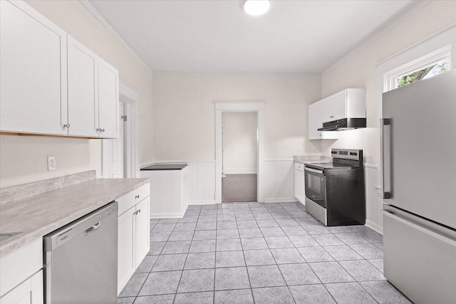 kitchen with appliances with stainless steel finishes, light countertops, light tile patterned flooring, under cabinet range hood, and white cabinetry
