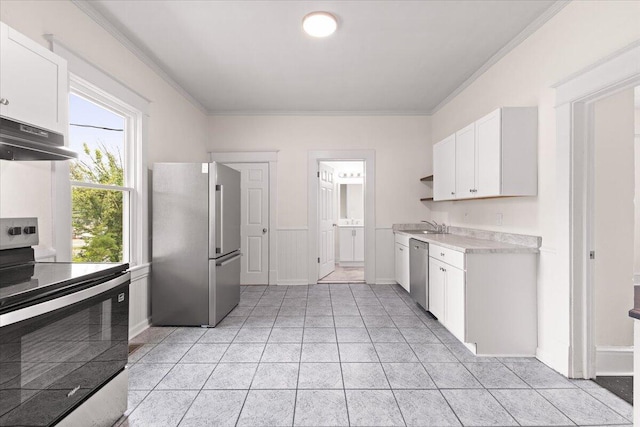 kitchen featuring light countertops, stainless steel appliances, white cabinetry, under cabinet range hood, and ornamental molding