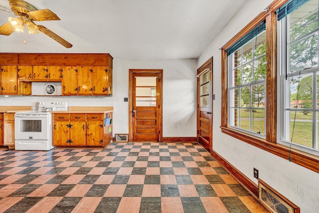 7080 Oak Level Rd, Bassett, VA 24055 - kitchen with baseboards, visible vents, white electric stove, and a healthy amount of sunlight