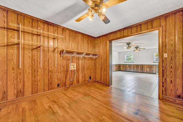 7080 Oak Level Rd, Bassett, VA 24055 - spare room featuring wooden walls, a ceiling fan, and wood finished floors