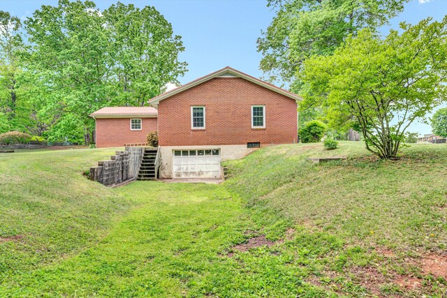 7080 Oak Level Rd, Bassett, VA 24055 - view of home's exterior with a garage, brick siding, stairs, a lawn, and driveway