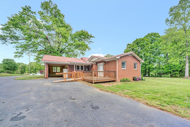 7080 Oak Level Rd, Bassett, VA 24055 - ranch-style home featuring brick siding, aphalt driveway, a wooden deck, and a front yard