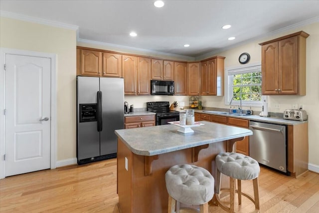 330 Sheliah Ct, Blacksburg, VA 24060 - kitchen featuring light wood finished floors, a breakfast bar area, a sink, black appliances, and ornamental molding