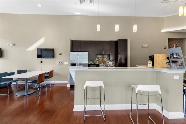 330 Sheliah Ct, Blacksburg, VA 24060 - kitchen featuring visible vents, a kitchen bar, stainless steel fridge with ice dispenser, light countertops, and dark wood-style floors