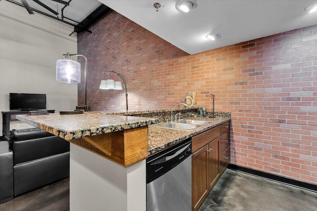 kitchen featuring brick wall, dishwasher, a sink, concrete floors, and a high ceiling
