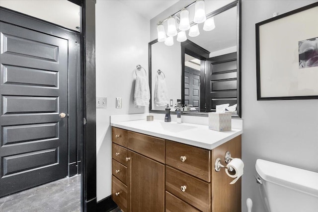 half bathroom with vanity and toilet