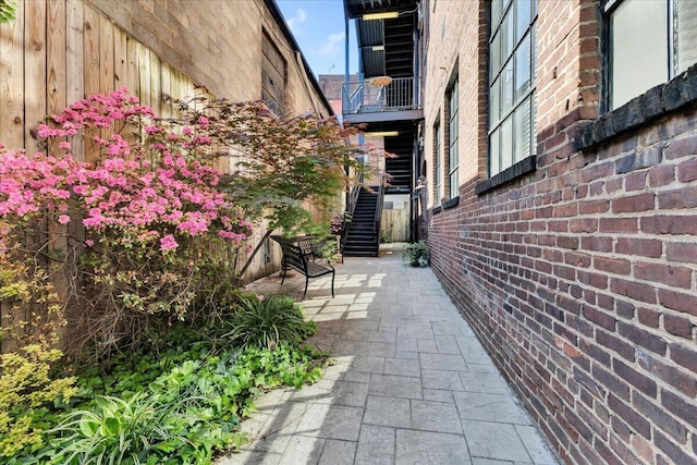 view of property's community with a patio and stairway