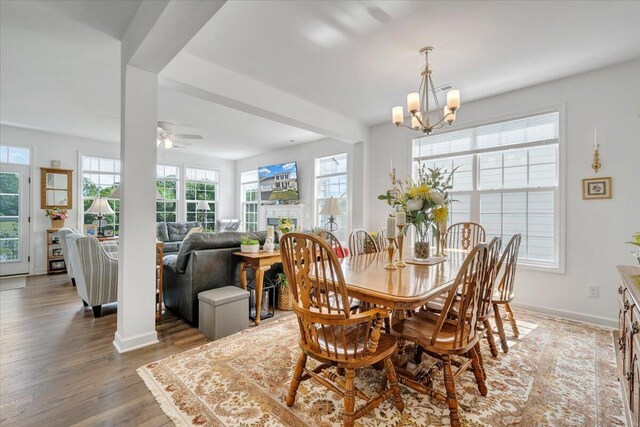 dining room featuring plenty of natural light, baseboards, and light wood-type flooring