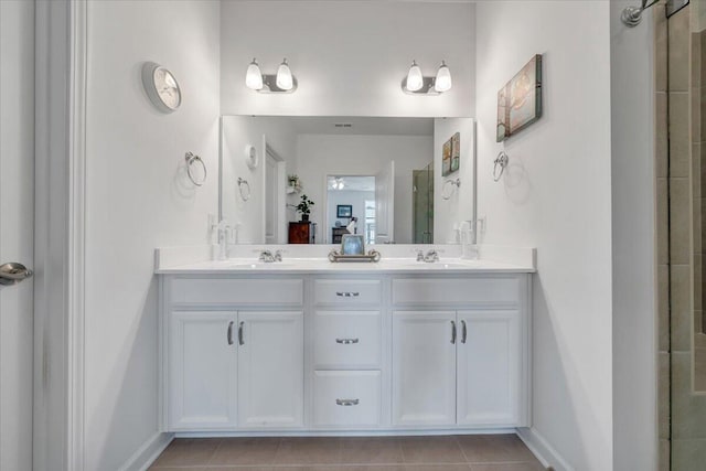 bathroom featuring a sink, baseboards, an enclosed shower, and double vanity